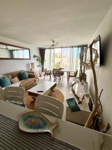 a living room with a couch and a table at T2 duplex- piscine- vue mer in Saint-Paul
