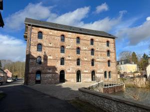 a large brick building with a lot of windows at Suite Véloscénie in Lèves +6 photos