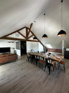 a large dining room with a long table and chairs at Suite Rivière in Lèves