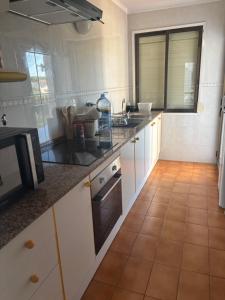 a kitchen with white cabinets and a counter top at Appartement Cambrils in Cambrils