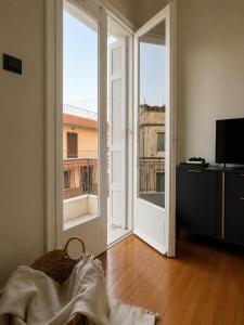 an empty room with an open door to a balcony at Retro Apartment Patras in Patra