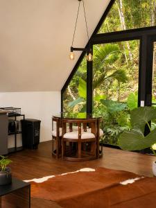 a dining room with a table and a large window at Private Luxury A-Frame with Jacuzzi & Mountain View in San Francisco +14 photos