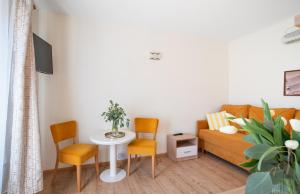 a living room with a couch and a table and chairs at Gwarek Ośrodek nad Morzem Pokoje z wyżywieniem in Międzywodzie +73 photos