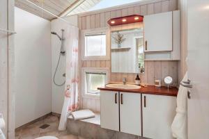 a bathroom with a sink and a shower at 402-Harboore-Flyvholmvej-23 in Harboør +24 photos