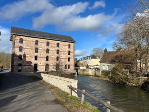 an old brick building next to a river at Suite Rivière in Lèves