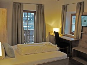 
a bedroom with a bed and a window at Mammhofer Suite & Breakfast in Oberammergau
