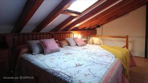 a bedroom with a bed with pillows on it at Casa Coba in Camijanes