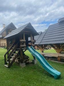 a playground with a slide in front of a building at Gawra Werlas in Werlas