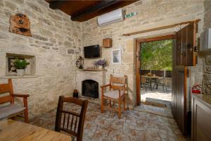 a living room with a stone wall with a fireplace at Villa Diamant 1860 in Monókhoron
