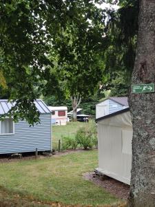 a street sign on a tree next to two houses at TIthome in Cunlhat +1 photo