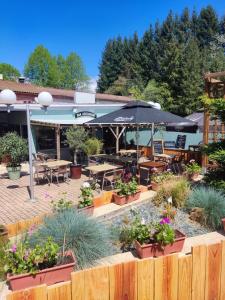 a patio with tables and chairs and an umbrella at TIthome in Cunlhat
