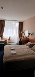a hotel room with a bed and a desk at Alka guest house in Palanga