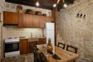 a kitchen with a table and a white refrigerator at Villa Diamant 1860 in Monókhoron