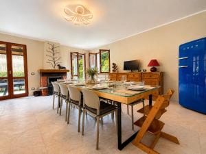 a dining room with a long table and chairs at Villa dei Mumi in Luino