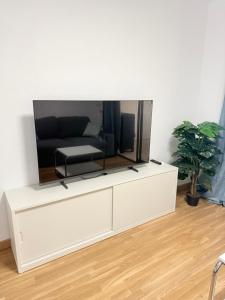 a living room with a tv on a white dresser at Castle Harbour 209 in Los Cristianos