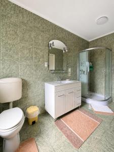 a bathroom with a toilet and a sink and a mirror at Hotel Casa Italia in Calafat +41 photos