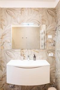 a bathroom with a white sink and a mirror at L'angolo del Forte in Rivoli Veronese +64 photos