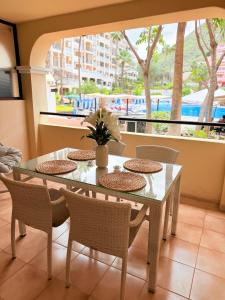 a dining room with a table and chairs and a window at Castle Harbour 209 in Los Cristianos