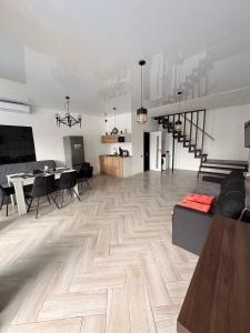 a living room with a couch and a wooden floor at White Villas Koblevo in Koblevo
