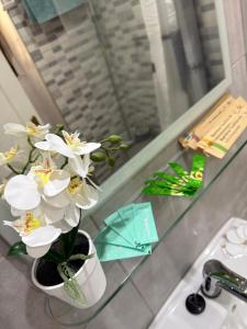 a vase with white flowers sitting on a glass table at Castle Harbour 209 in Los Cristianos +56 photos