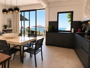 a kitchen and dining room with a table and chairs at Atlantic View Loft - Spa & Sunset in La Orotava