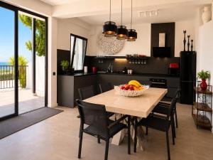 a kitchen and dining room with a table and chairs at Atlantic View Loft - Spa & Sunset in La Orotava +9 photos