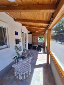 a porch with a swing in a house at Apartment Lela - self check-in and check-out in Otočac +4 photos