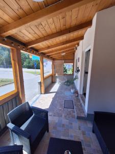 a living room with chairs and a wooden ceiling at Apartment Lela - self check-in and check-out in Otočac