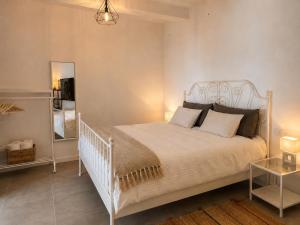 a bedroom with a white bed and a mirror at Atlantic View Loft - Spa & Sunset in La Orotava