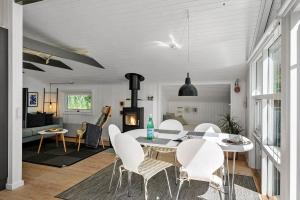 a dining room and living room with a table and chairs at JB274-Fjerritslev-Ronnevej-10 in Kollerup