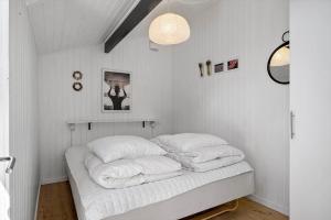 a bedroom with a bed with white pillows at JB274-Fjerritslev-Ronnevej-10 in Kollerup
