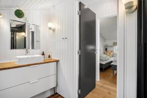 a bathroom with a sink and a mirror at JB274-Fjerritslev-Ronnevej-10 in Kollerup +19 photos