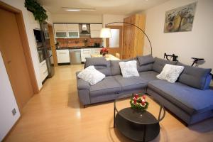 a living room with a couch and a table at Slunný byt v Berouně in Beroun