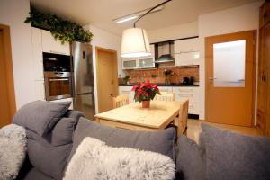 a living room with a couch and a wooden table at Slunný byt v Berouně in Beroun +8 photos