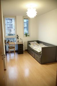 a bedroom with a bed and a desk in it at Slunný byt v Berouně in Beroun