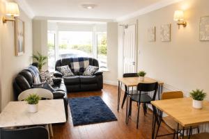 a living room with a couch and chairs and tables at The Boutique Bungalow in Bundoran