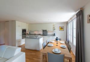 a kitchen and dining room with a table and chairs at Chalet Mittaghorn Apt 7 in Wengen