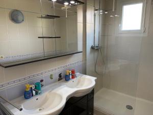 a white bathroom with a sink and a shower at chez christian&astrid Next to Disneyland Paris in Penchard +28 photos