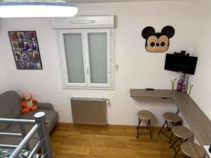 a small living room with a couch and a desk at chez christian&astrid Next to Disneyland Paris in Penchard