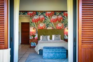 a bedroom with a bed with a floral wall at Zeven Eike Homestead in Stellenbosch +96 photos