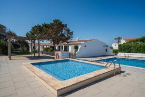 a swimming pool in front of a house at Villas Estrellas 11 in Ciutadella
