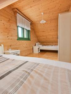a bedroom in a log cabin with a bed at STD Bešević "Naše Brdo" Ivanjica in Ivanjica