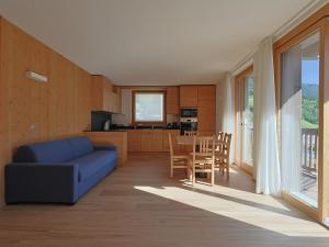 a living room with a blue couch and a table at Bormio BM0 - Tutta Bormio a Zero stress in Bormio