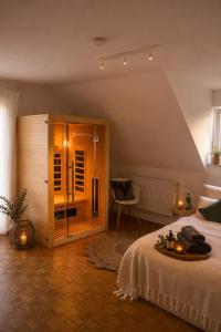 a bedroom with a bed and a glass door at Ferienwohnung Eifelglück in Pelm +9 photos