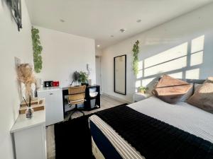 a bedroom with a bed and a desk in it at The Grove Sutton in Sutton +10 photos