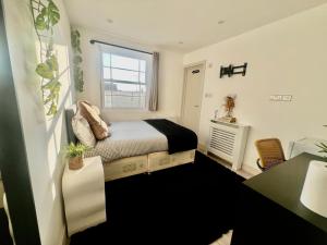 a bedroom with a bed and a window at The Grove Sutton in Sutton