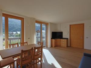 a dining room with a table and chairs and a television at Bormio BM0 - Tutta Bormio a Zero stress in Bormio