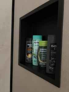 a shelf with a bunch of products on a wall at Tiny house U Lasiček in Perštejn