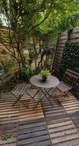 a table with a potted plant sitting on a patio at Charmant studio,Terrasse et Parking in Montpellier