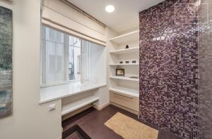 a bathroom with a walk in shower next to a window at Boutique Flat - Spa Shower - Sound System in Tallinn +26 photos